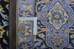 Backside of handmade 2000s Kashan rug showing knot structure and weave density