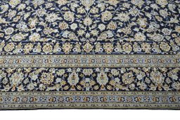 Corner detail of 2000s Kashan rug showing border pattern and Wool pile