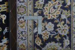 Backside of handmade 2000s Kashan rug showing knot structure and weave density