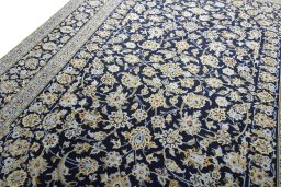 Backside of handmade 2000s Kashan rug showing knot structure and weave density