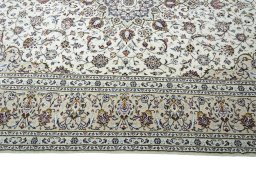 Corner detail of 2000s Kashan rug showing border pattern and Wool pile