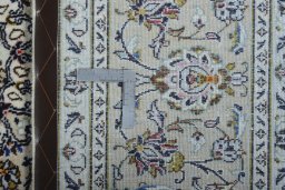 Backside of handmade 2000s Kashan rug showing knot structure and weave density