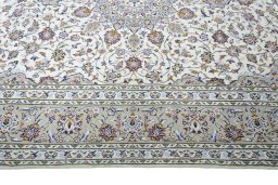 Corner detail of 2000s Kashan rug showing border pattern and Wool pile