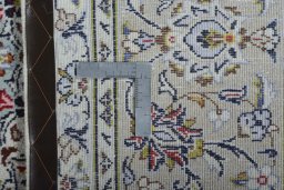 Backside of handmade 2000s Kashan rug showing knot structure and weave density