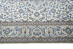 Corner detail of 2000s Kashan rug showing border pattern and Wool pile