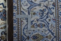 Backside of handmade 2000s Kashan rug showing knot structure and weave density