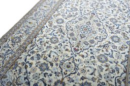 Backside of handmade 2000s Kashan rug showing knot structure and weave density