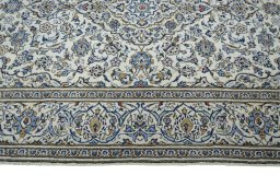 Corner detail of 2000s Kashan rug showing border pattern and Wool pile
