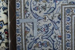 Backside of handmade 2000s Kashan rug showing knot structure and weave density