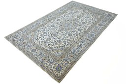 Corner detail of 2000s Kashan rug showing border pattern and Wool pile