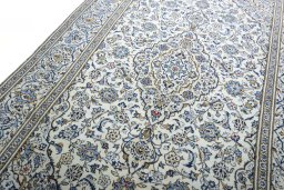 Backside of handmade 2000s Kashan rug showing knot structure and weave density