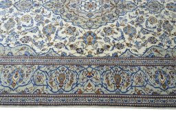 Corner detail of 2000s Kashan rug showing border pattern and Wool pile