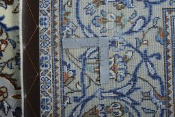 Backside of handmade 2000s Kashan rug showing knot structure and weave density