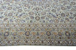 Corner detail of 2000s Kashan rug showing border pattern and Wool pile