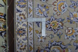 Backside of handmade 2000s Kashan rug showing knot structure and weave density