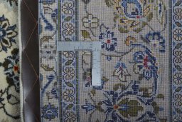 Backside of handmade 2000s Kashan rug showing knot structure and weave density