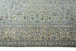 Corner detail of 2000s Kashan rug showing border pattern and Wool pile