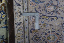 Backside of handmade 2000s Kashan rug showing knot structure and weave density
