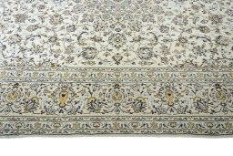 Corner detail of 2000s Kashan rug showing border pattern and Wool pile