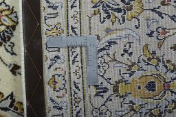 Backside of handmade 2000s Kashan rug showing knot structure and weave density