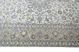 Corner detail of 2000s Kashan rug showing border pattern and Wool pile