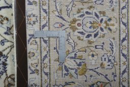 Backside of handmade 2000s Kashan rug showing knot structure and weave density