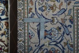 Backside of handmade 2000s Kashan rug showing knot structure and weave density