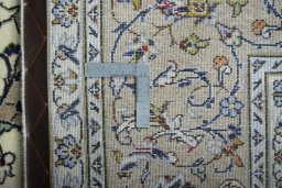 Backside of handmade New Kashan rug showing knot structure and weave density