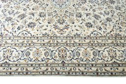 Corner detail of 2000s Kashan rug showing border pattern and Wool pile