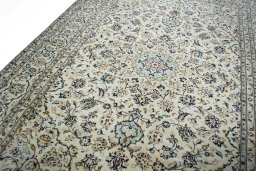Backside of handmade 2000s Kashan rug showing knot structure and weave density