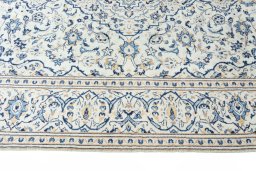 Corner detail of New Kashan rug showing border pattern and Wool pile