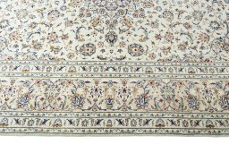 Corner detail of New Kashan rug showing border pattern and Wool pile