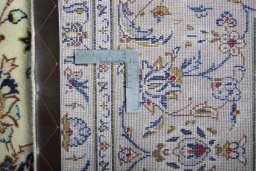 Backside of handmade New Kashan rug showing knot structure and weave density