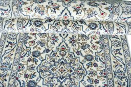 Corner detail of 2000s Kashan rug showing border pattern and Wool pile