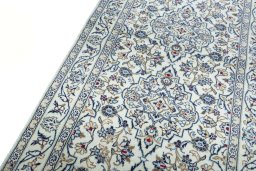 Backside of handmade 2000s Kashan rug showing knot structure and weave density