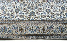 Corner detail of 2000s Kashan rug showing border pattern and Wool pile