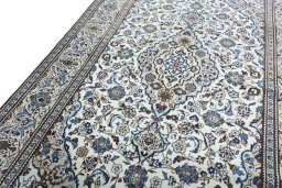 Backside of handmade 2000s Kashan rug showing knot structure and weave density