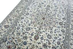 Backside of handmade New Kashan rug showing knot structure and weave density
