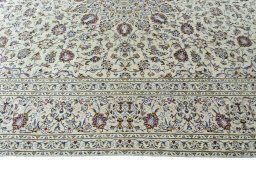 Corner detail of 2000s Kashan rug showing border pattern and Wool pile