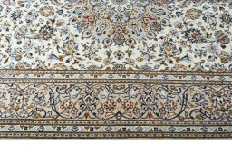 Corner detail of 2000s Kashan rug showing border pattern and Wool pile