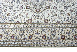 Corner detail of 2000s Kashan rug showing border pattern and Wool pile