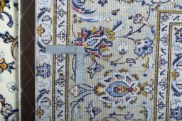 Backside of handmade 2000s Kashan rug showing knot structure and weave density