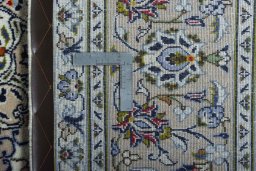Backside of handmade 2000s Kashan rug showing knot structure and weave density