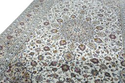 Backside of handmade 2000s Kashan rug showing knot structure and weave density