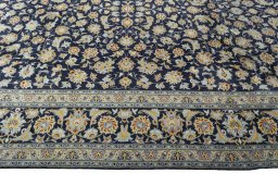 Corner detail of 2000s Kashan rug showing border pattern and Wool pile