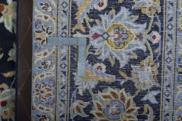 Backside of handmade 2000s Kashan rug showing knot structure and weave density