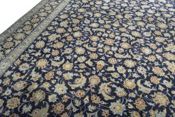 Backside of handmade 2000s Kashan rug showing knot structure and weave density