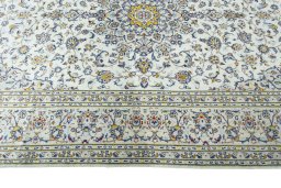 Corner detail of 2000s Kashan rug showing border pattern and Wool pile
