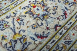 Close-up detail of 2000s Kashan rug from Iran / Persia showing Wool weave