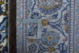 Backside of handmade 2000s Kashan rug showing knot structure and weave density